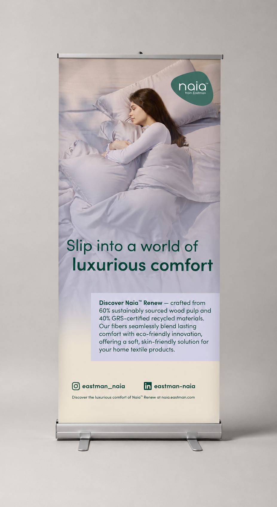 Naia™ Renew home textile roll-up banner — "Slip into a world of luxurious comfort"